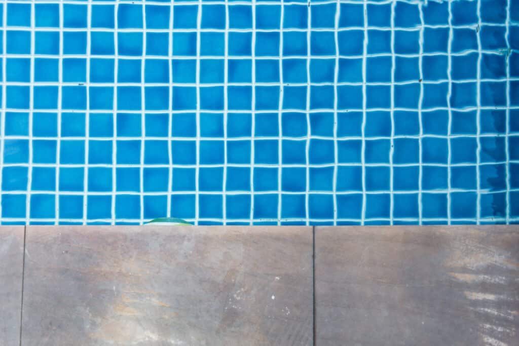 Close-up of blue pool tiles with tile edge at Summer Pools Inc.