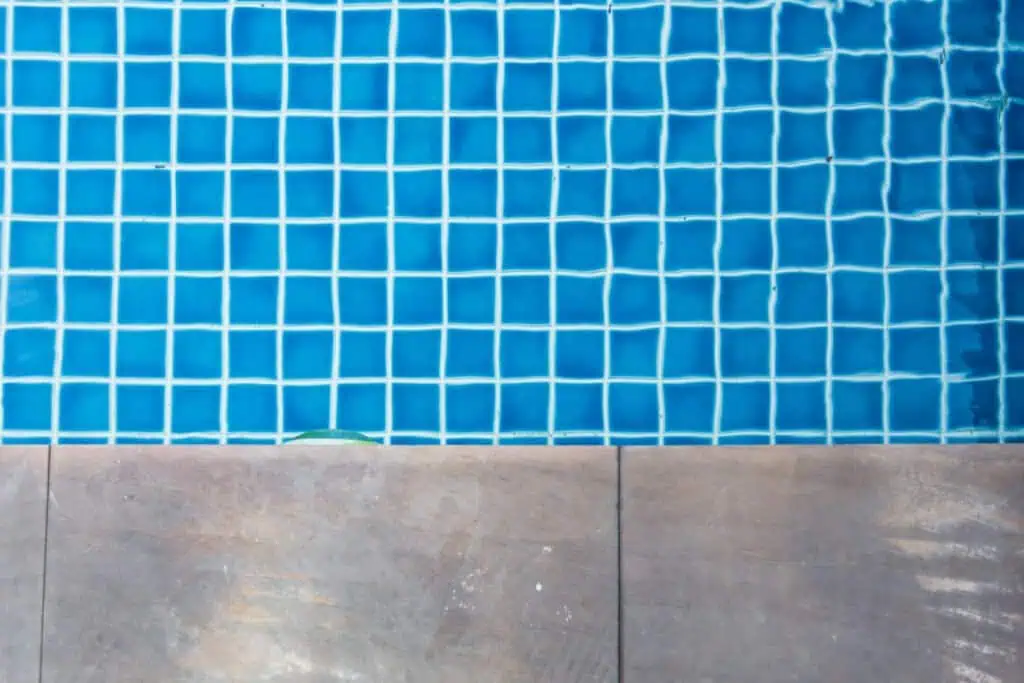 Close-up of blue pool tiles with tile edge at Summer Pools Inc.